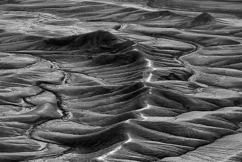Ridge and Drainage Patterns Black and white photo of an eroded ridge with drainage patterns resembling a spine and ribs, taken by Bob Hart in Hanksville, Utah after sunrise.