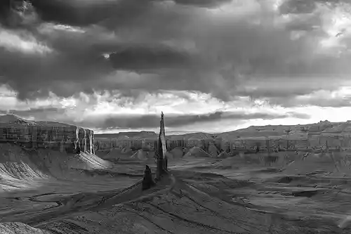 Spire in Side Light at Sunset Black and white photo of Long Dong Silver spire at sunset with dramatic clouds and side-lit cliffs, taken by Bob Hart in the Utah desert.