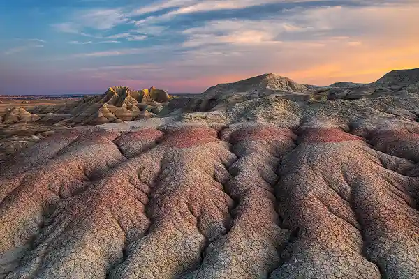 Beautiful erosion patterns play across the foreground in this dramatic sunset photo. This is one of our photography locations during our workshop in Badlands National Park, South Dakota.