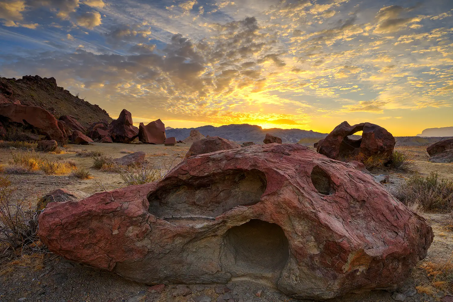 Sunrise color above sculpted desert rocks near Indian Head in Big Bend National Park.