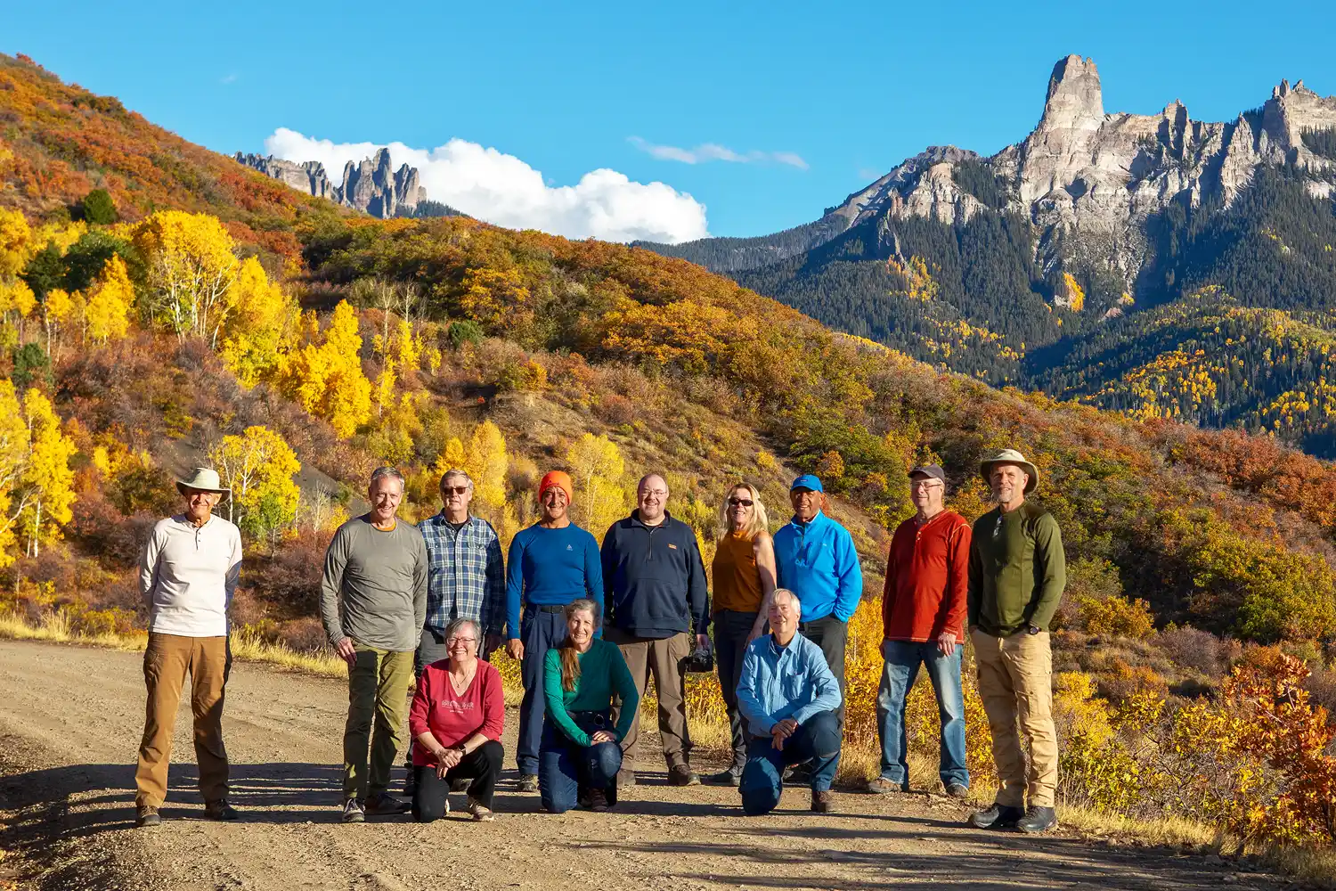 Workshop participants in Colorado, with vibrant fall foliage and mountain backdrop.