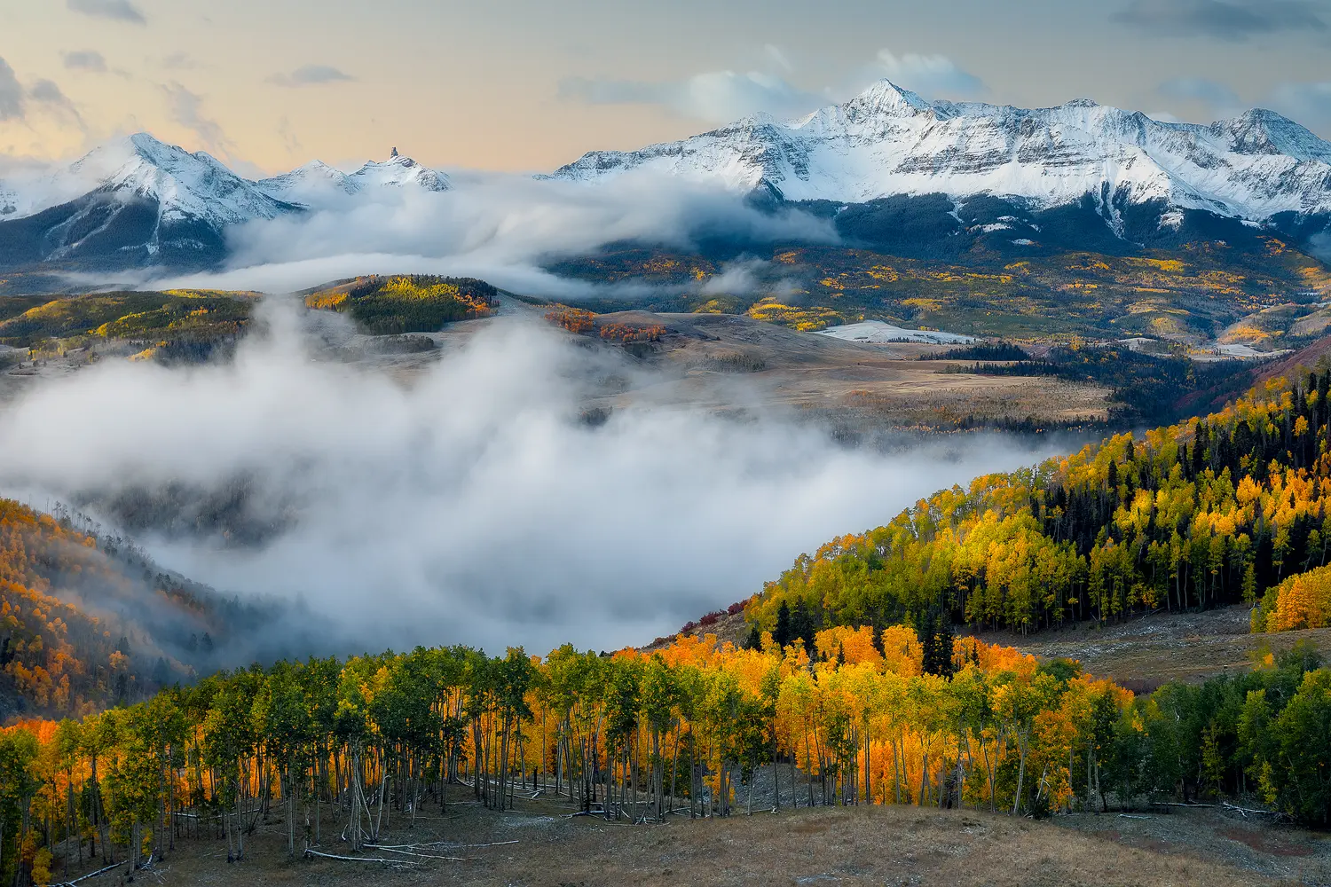 Wilson Peak at sunrise, surrounded by autumn foliage in the Colorado mountains.