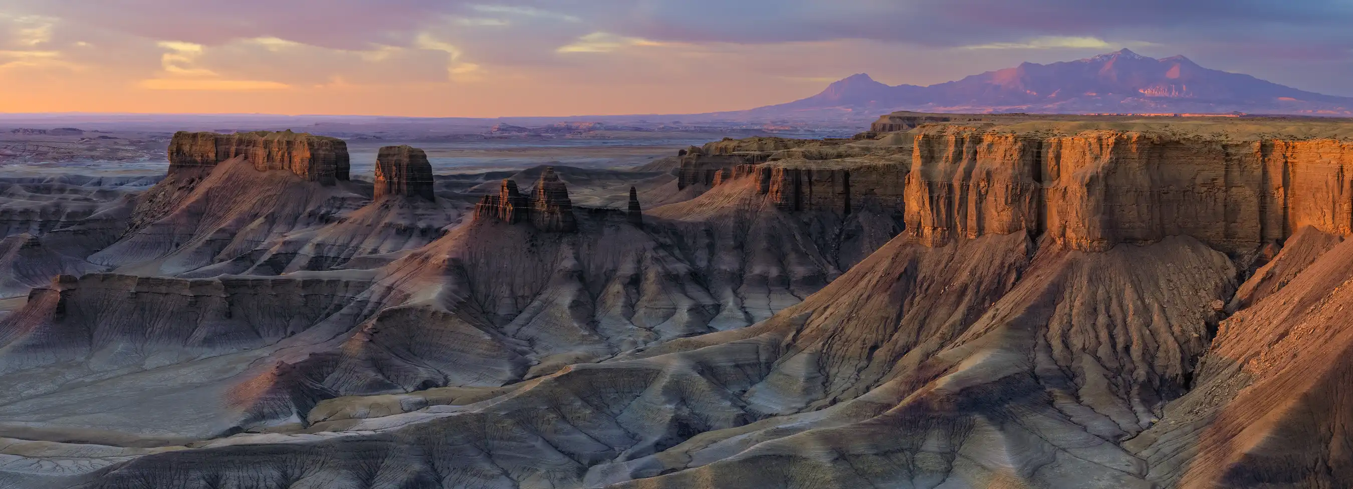 Sweeping panoramic view of Moonscape Overlook under warm morning light near Hanksville, Utah.