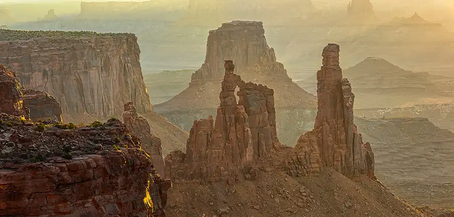 Morning haze separating sandstone spires and mesas in Canyonlands National Park.