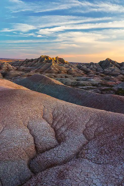 Evening light revealing dendritic erosion patterns leading into the layered badlands of Badlands National Park.