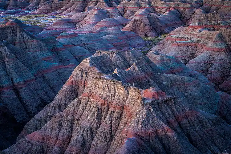 The first blue light of dawn revealing layered ridges at Big Badlands Overlook in Badlands National Park.