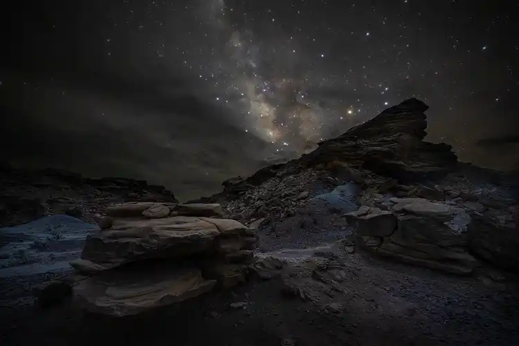 Layered volcanic rocks leading toward the Milky Way at Exhibit Ridge in Big Bend National Park.