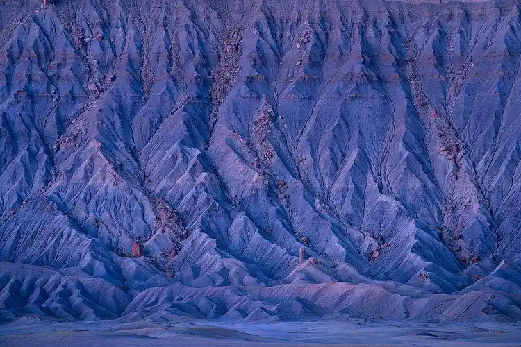 Blue hour revealing an intricate maze of gullies below Factory Butte near Hanksville, Utah.