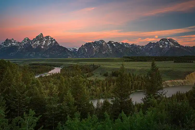 The Snake River winding through Jackson Hole beneath the Teton Range at sunrise, Grand Teton National Park.
