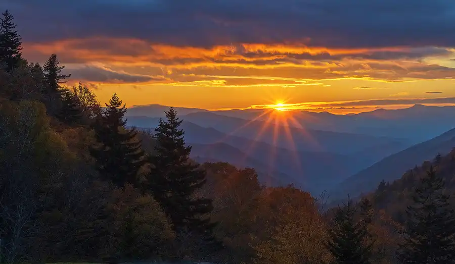 Morning sunstar rising above layered Great Smoky Mountains from Newfound Gap Road in Great Smoky Mountains National Park.