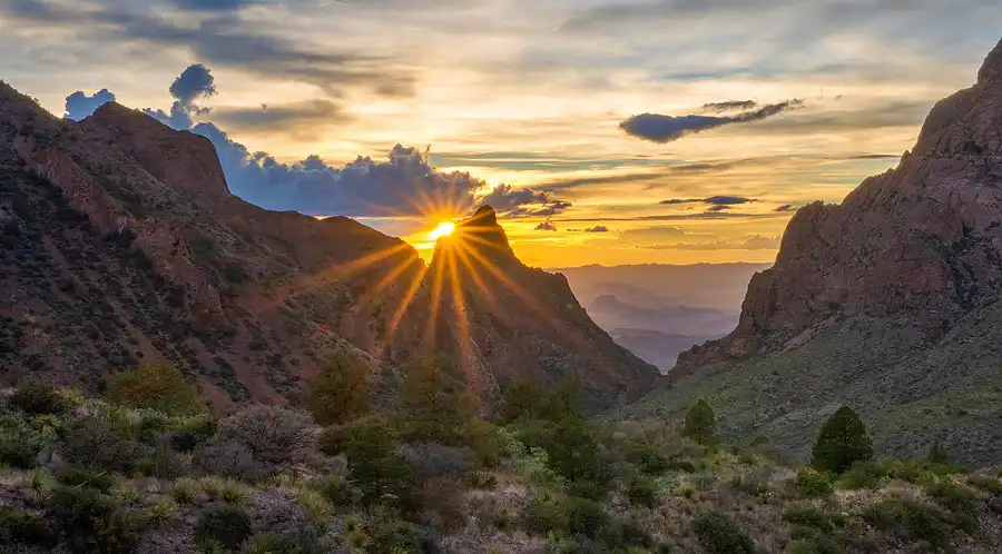Sunstar at sunset framed by The Window and rugged canyon walls in the Chisos Mountains, Big Bend National Park.