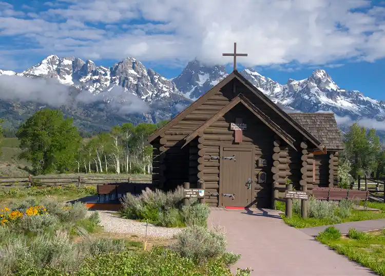 The Chapel of the Transfiguration with the Teton Range rising behind in Grand Teton National Park.