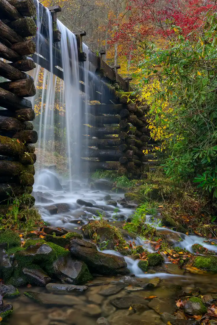 Workshop location; The soft light of early morning allows for a long exposure, which blurs the moving water spilling over the sides of the elevated water chute supplying Mingus Mill, in Great Smoky Mountains National Park. Above and to the side of the chute autumn colors decorate the trees of the hardwood forest.