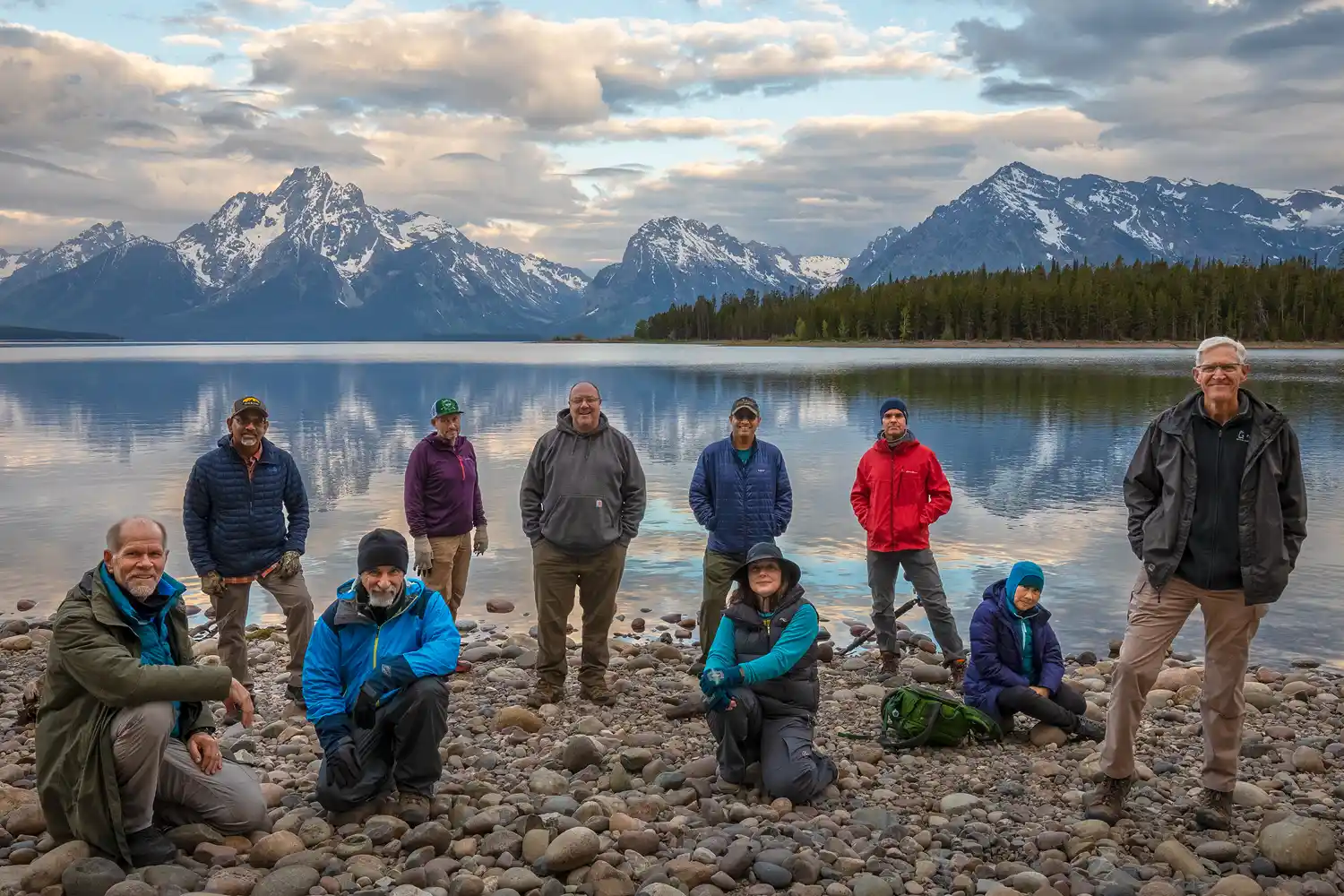 Group photo of workshop participants on the shore of Jackson Lake with Mount Moran in the background.