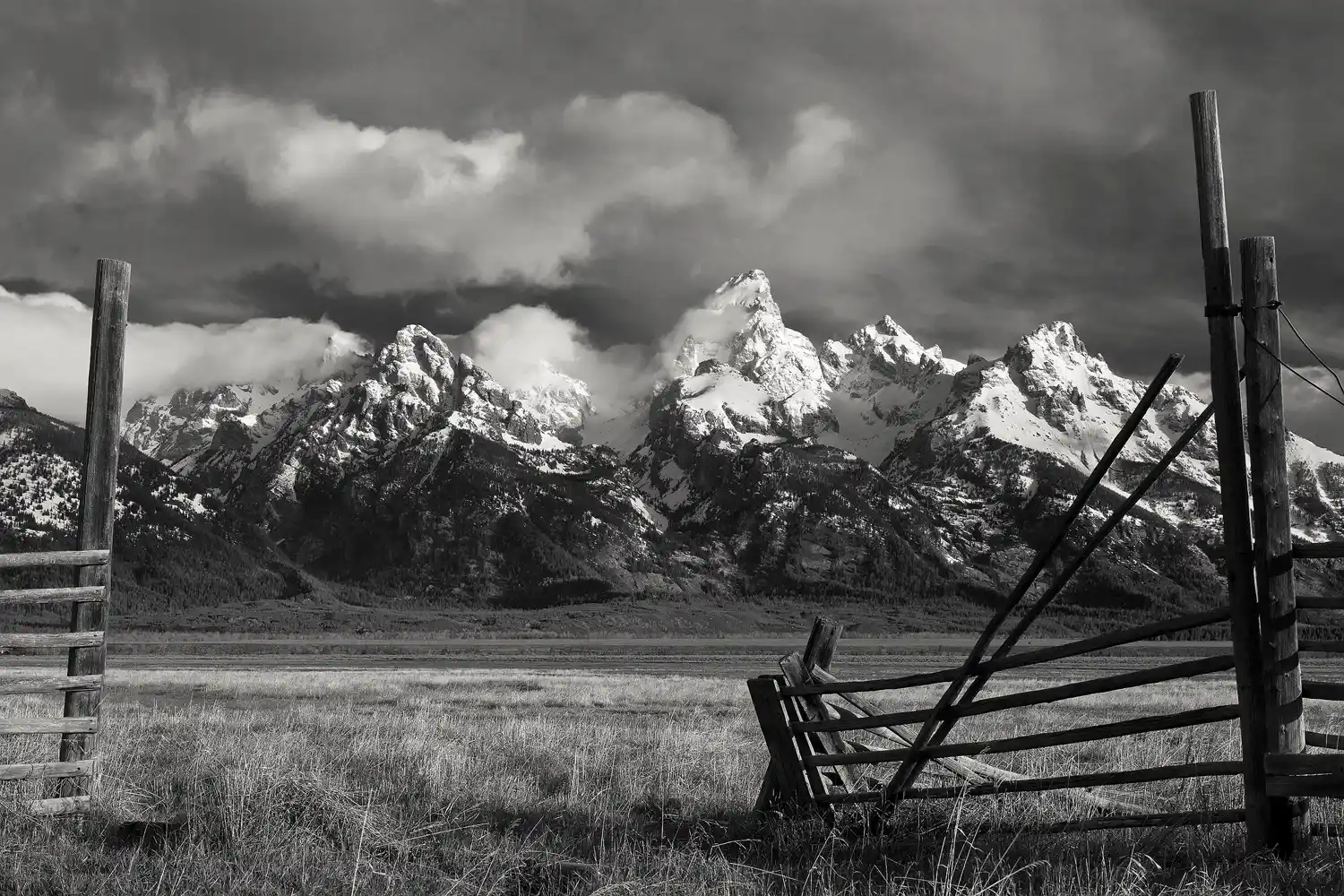 A rustic fence gate at Mormon Row with the Teton mountains behind it.
