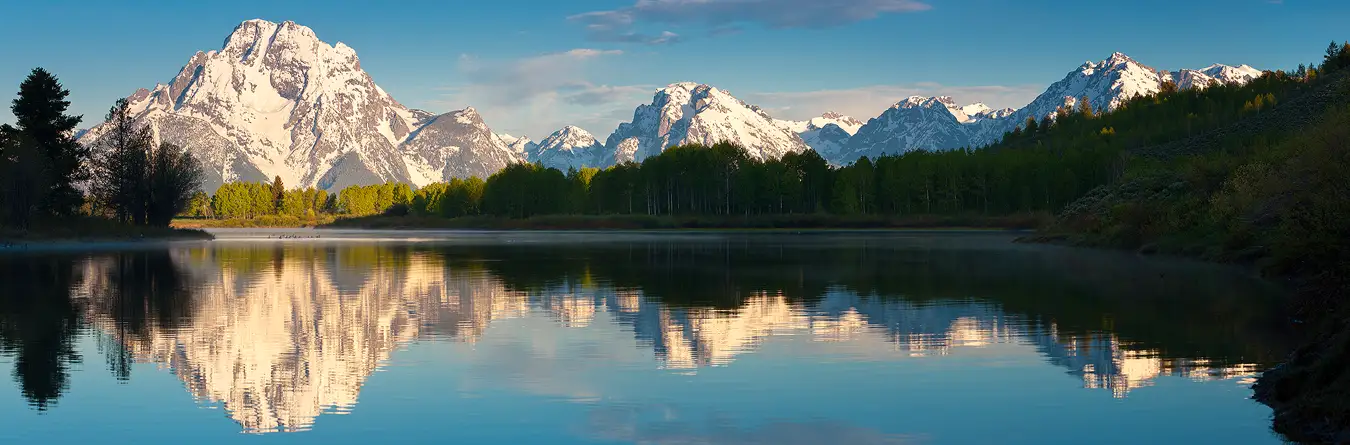 Workshop location; Spring, morning panorama of snow laden Mount Moran reflecting in Oxbow Bend, Snake River, Grand Teton National Park.