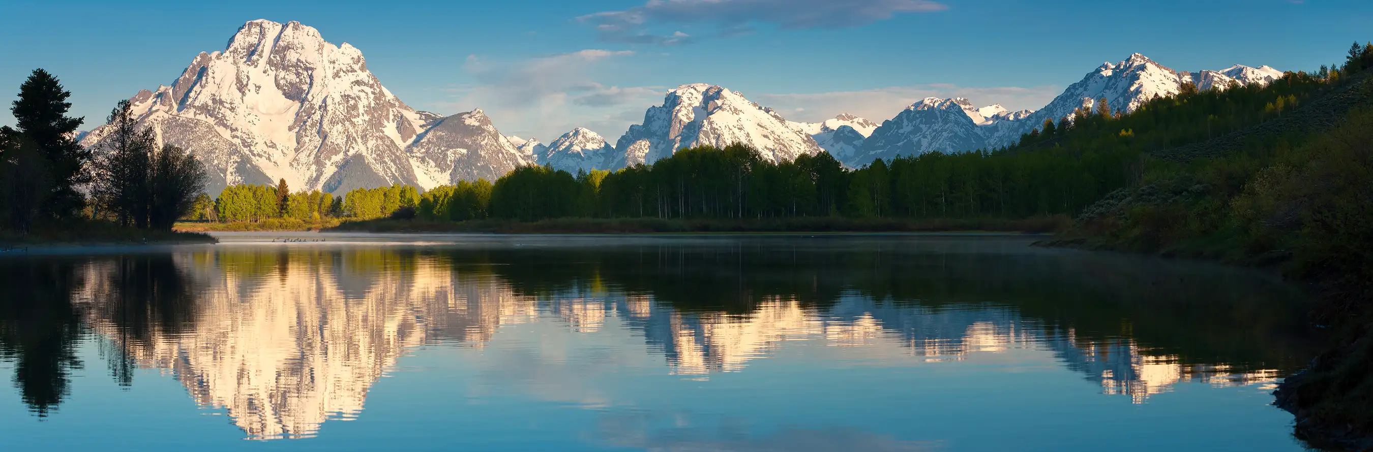 Snow-capped Mount Moran reflecting in Oxbow Bend on the Snake River in Grand Teton National Park.